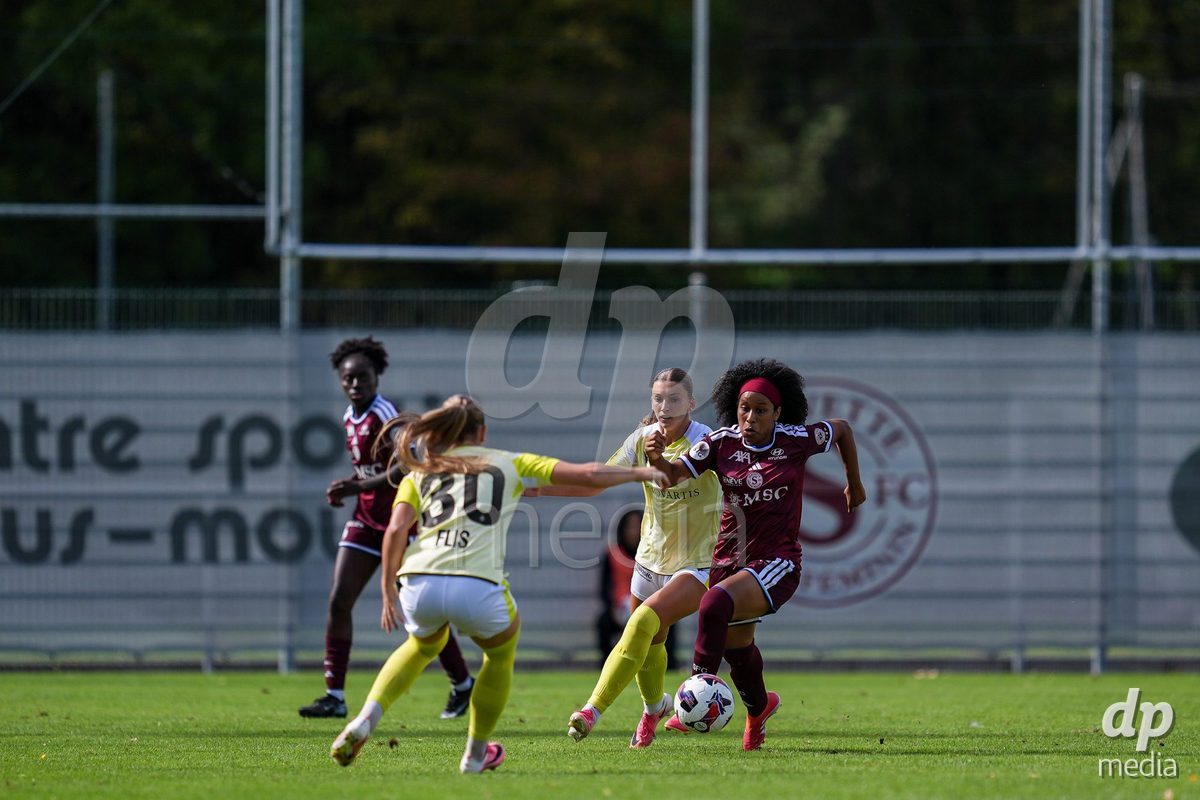 Geneva, Switzerland - August 29: Mickaella Francoise Halooa Cardia of Servette (R) brings the ball forward during the AXA Women's Super League match between Servette FC Chenois Feminin and FC Basel 1893 at Stade de Trois-Chene on August 29, 2026 in Geneva, Switzerland.