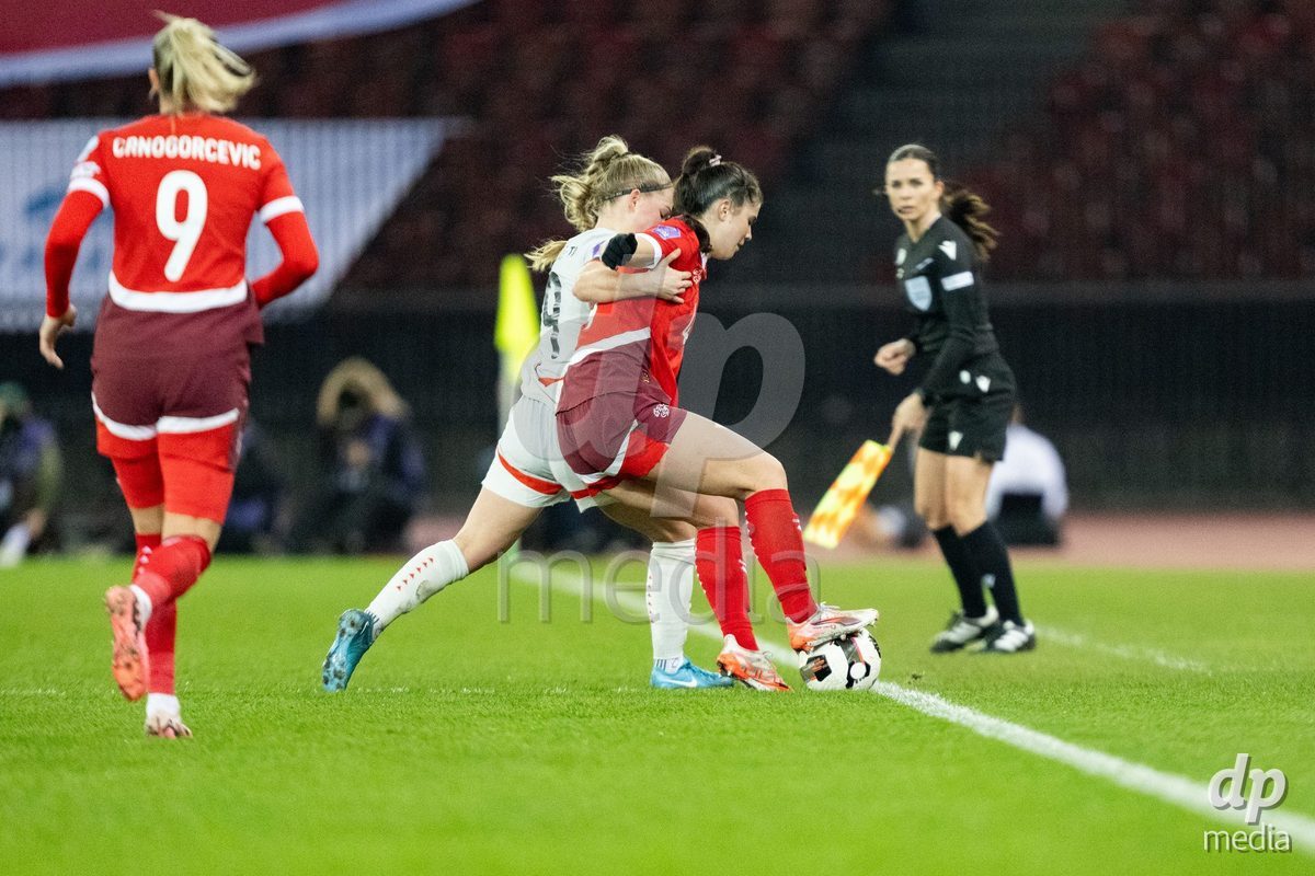 Aslaug Munda Gunnlaugsdottir (9 Island) in action against Noemi Ivelj (4 Switzerland) during the UEFA Women's Nations League game between Switzerland and Island at Stadion Letzigrund in Zurich, Switzerland.