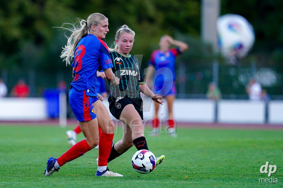Basel, Switzerland - September 4: Tabea Griss of St. Gallen  1879 (R) and Jacqueline Hand of FC Basel 1893 (L) battle for the ball during the AXA Women's Super League match between FC Basel 1893 and FC St. Gallen 1879 at Leichtathletikstadion on September 4, 2026 in Basel, Switzerland.