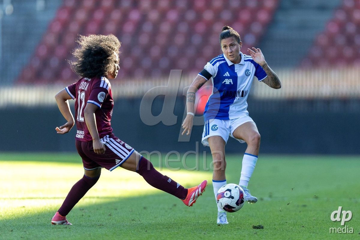 ZURICH, SWITZERLAND - September 6: Melanie Muller of GC Frauenfussball (R) passes the ball under pressure from Mickaella Cardia (Mickaëlla Cardia) of Servette FC Chenois Feminin (L)  during the AXA Women's Super League match between GC Frauenfussball and Servette FC Chenois Feminin at Letzigrund on September 6, 2026 in Zurich, Switzerland.