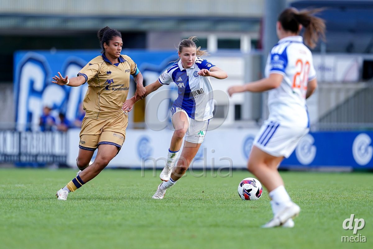NIEDERHASLI, SWITZERLAND - September 13: Giulia Looser of GC Frauenfussball (R) and Aldiana Amuchie of FC Luzern (L) battle for the ball during the AXA Women's Super League match between GC Frauenfussball and FC Luzern at GC Campus on September 13, 2026 in Niederhasli, Switzerland.