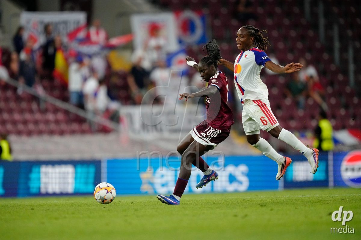 GENEVA, SWITZERLAND - SEPTEMBER 23: Melchie Dumornay of Olympique Lyon against Benedicte Simon of Servette FC Chenois Feminin during the UEFA Women's Champions League match between Servette FC Chenois Feminin and OL Lyonnes at Stade de Geneve on September 23, 2026 in Geneva, Switzerland.