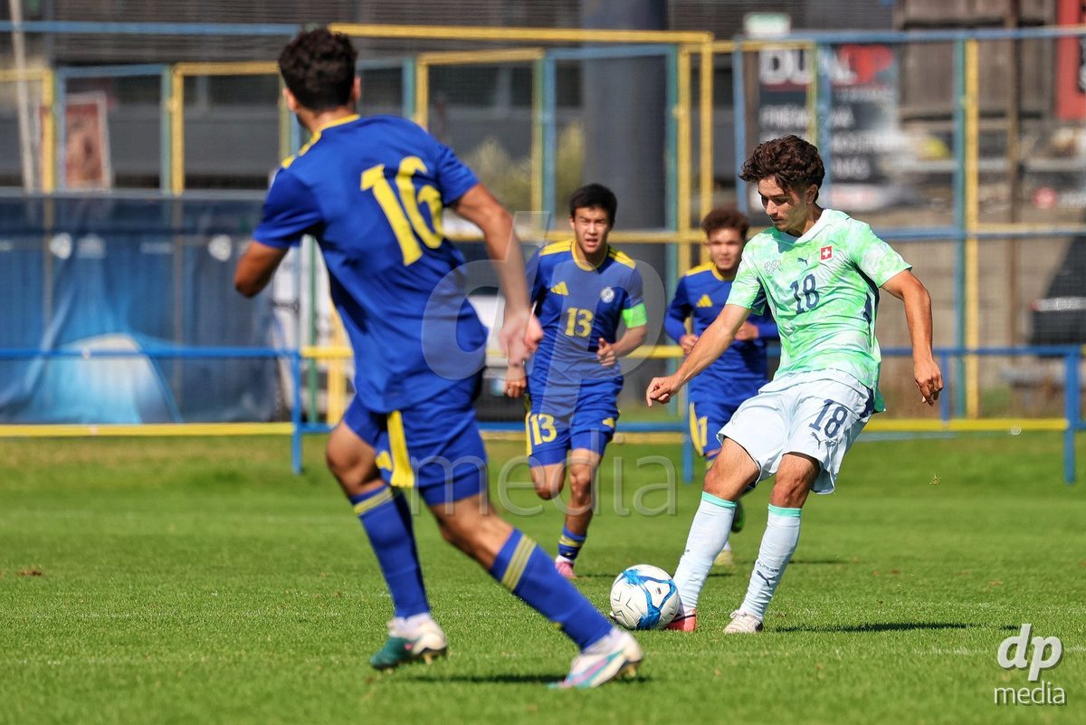 DUNAJSKA LUZNA, SLOVAKIA - SEPTEMBER 28: Denis Sahin 18 of Switzerland struggle for the ball during the friendly international football match between Kazakhstan U19 and Switzerland U19 on September 28, 2026 in Dunajska Luzna, Slovakia.