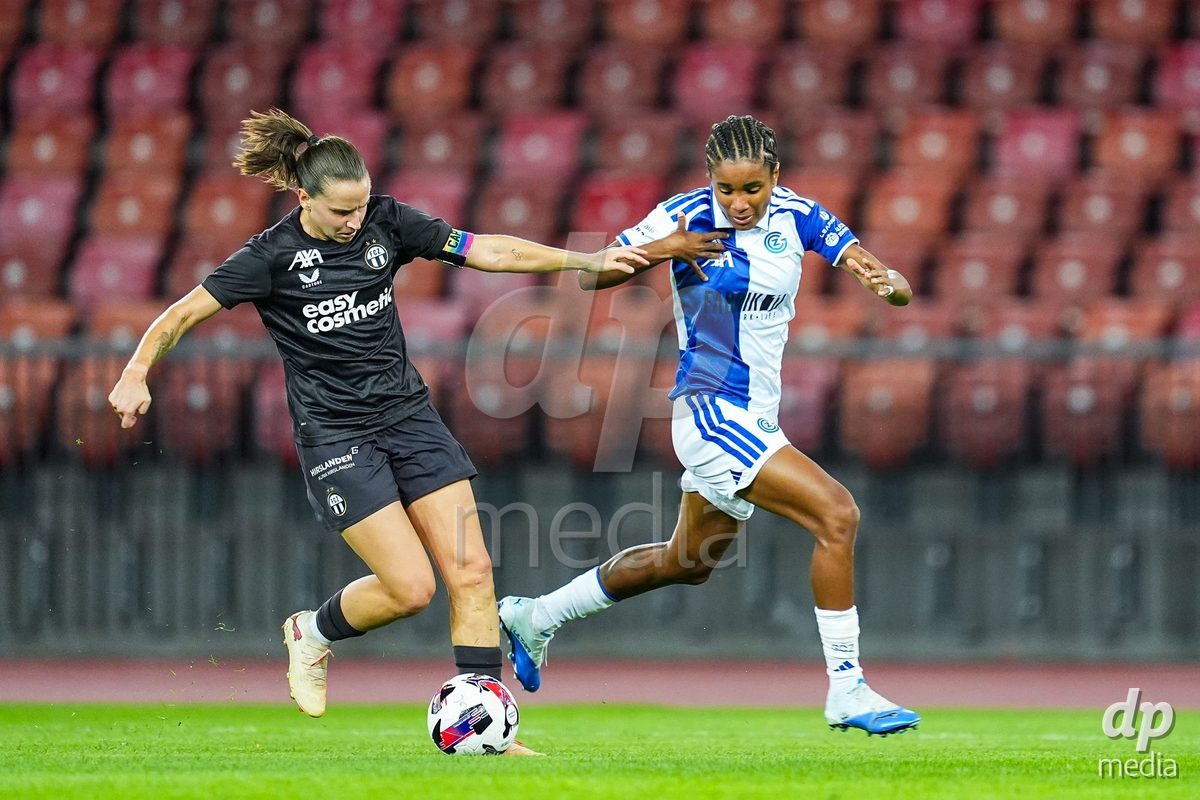 ZURICH, SWITZERLAND - OCTOBER 2: Naomi Megroz of FC Zurich (L) and Sury Lamontana of Grasshopper Club Zurich battle for the ball  during the AXA Women's Super League match between GC Frauenfussball and FC Zurich at Letzigrund on October 2, 2026 in Zurich, Switzerland.