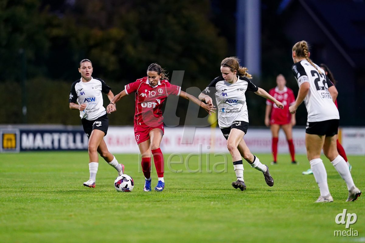 RAPPERSWIL, SWITZERLAND - OCTOBER 3: Evdokia Dimitrova Popadinova of FC Rapperswil-Jona (L) controls the ball during the AXA Women's Super League match between FC Rapperswil-Jona and FC Aarau Frauen at Grunfeld on October 3, 2026 in Rapperswil, Switzerland.