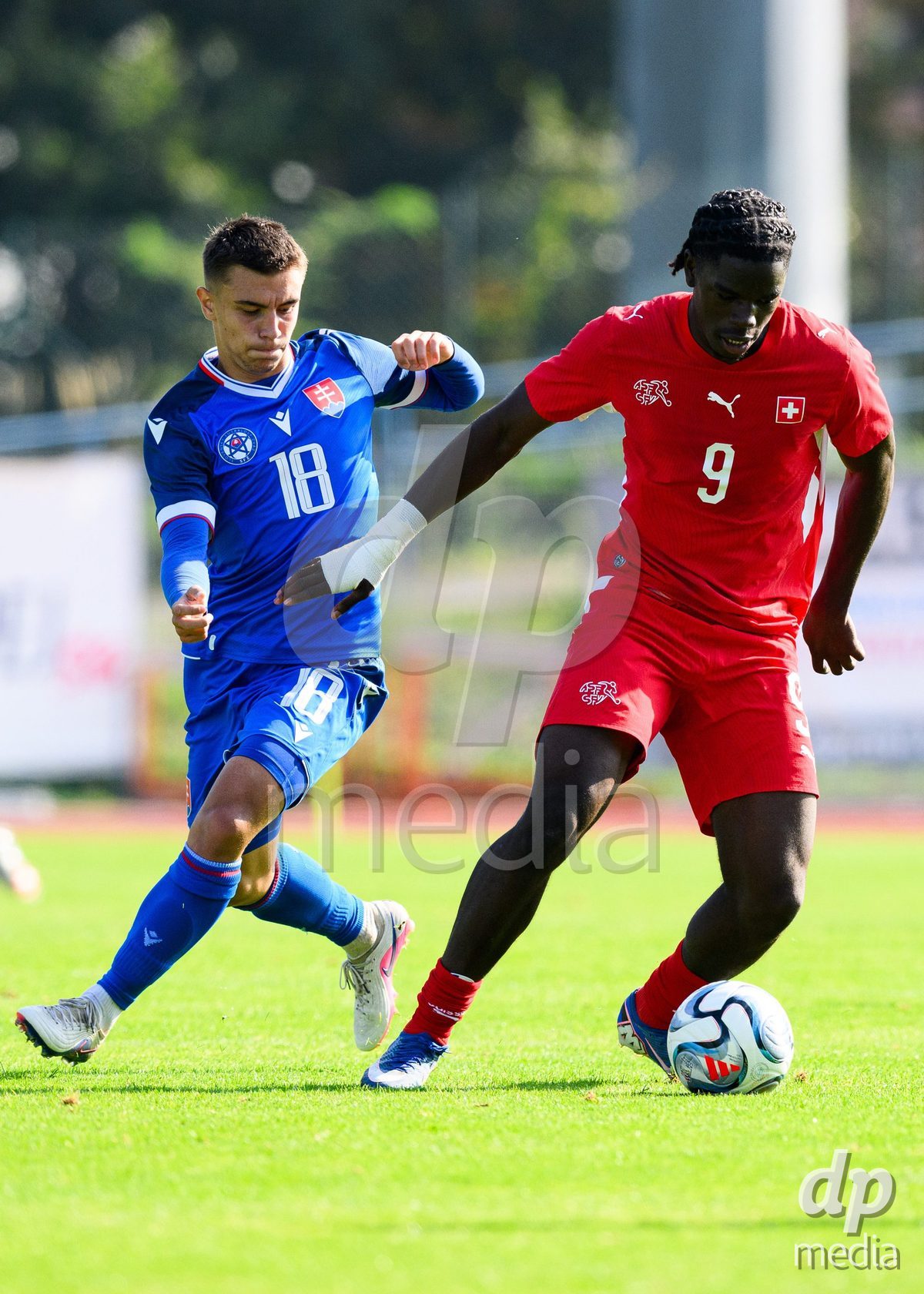 USTI NAD LABEM, CZECH REPUBLIC - OCTOBER 3: Shedrach Ogbodu of Switzerland and Tobias Jan Mirko of Slovakia during the International Friendly match between Slovakia and Switzerland on October 3, 2026 in Ustí nad Labem, Czech Republic.