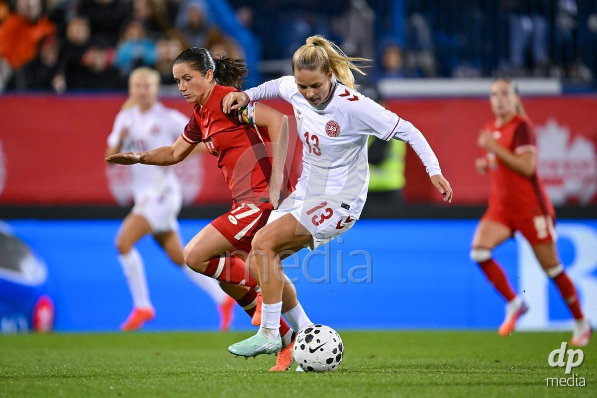 MONTREAL, CANADA - OCTOBER 9: Jessie Fleming of Canada (L) and Olivia Holdt of Denmark (R) battle for the ball (duel)  during the International Women's Friendly football match between Canada and Denmark at Stade Saputo on October 9, 2026 in Montreal, Canada.