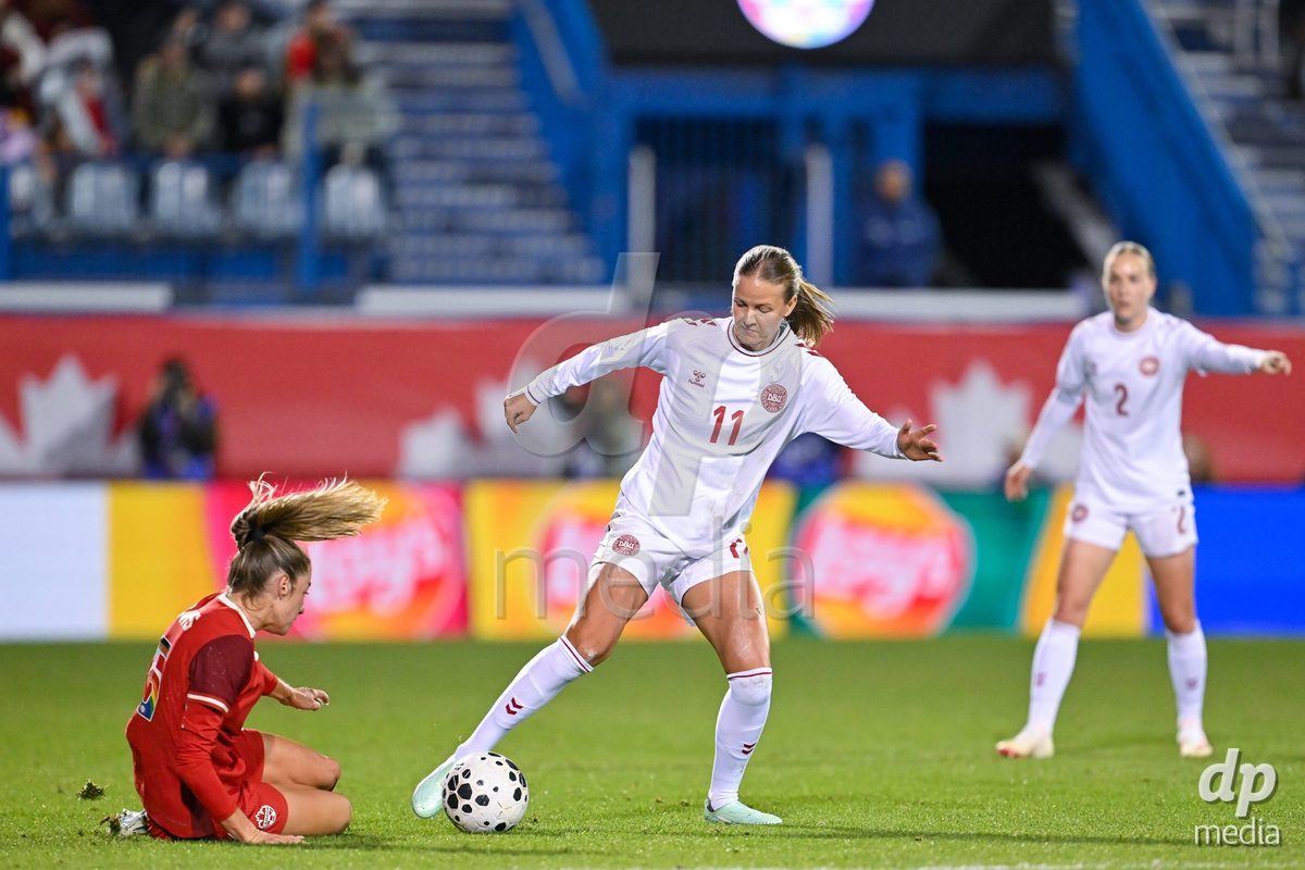 MONTREAL, CANADA - OCTOBER 9: Caroline Møller of Denmark (R) battles for the ball during the International Women's Friendly football match between Canada and Denmark at Stade Saputo on October 9, 2026 in Montreal, Canada.