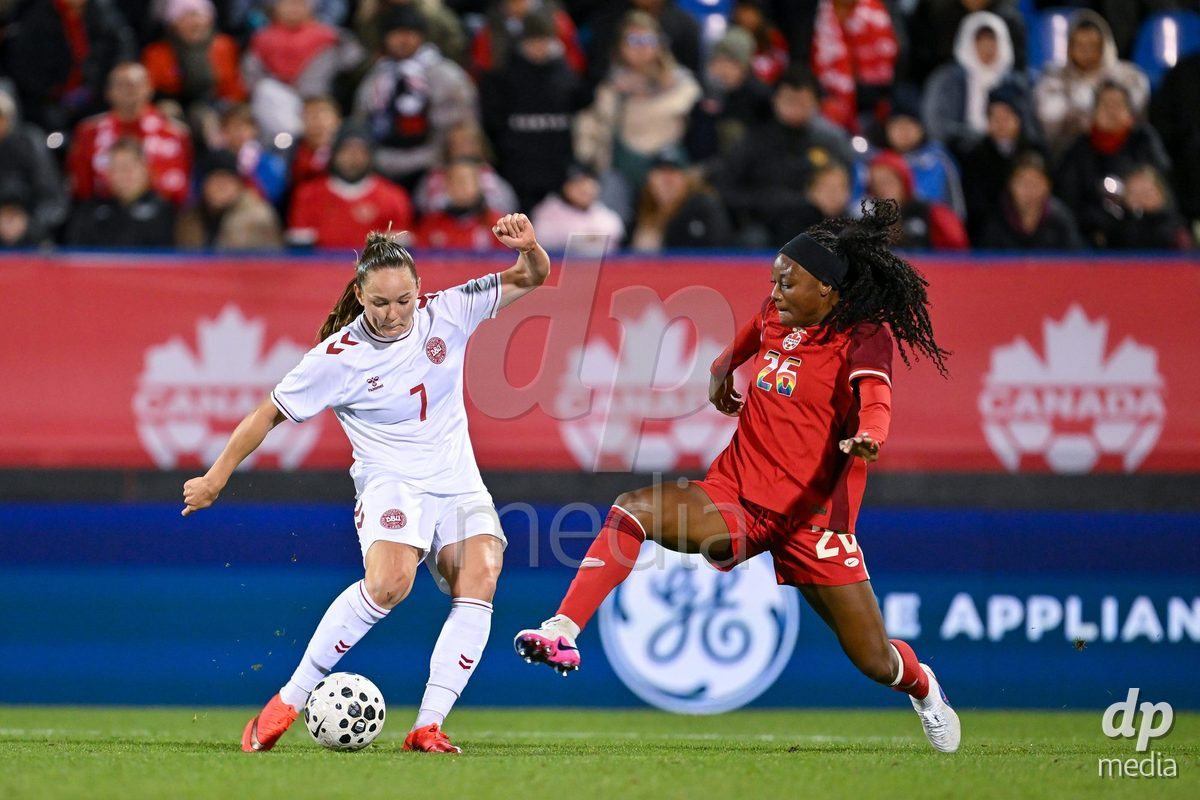 MONTREAL, CANADA - OCTOBER 9: Janni Thomsen of Denmark (L) and Elisabeth Tse of Canada  (R) battle for the ball (duel) during the International Women's Friendly football match between Canada and Denmark at Stade Saputo on October 9, 2026 in Montreal, Canada.