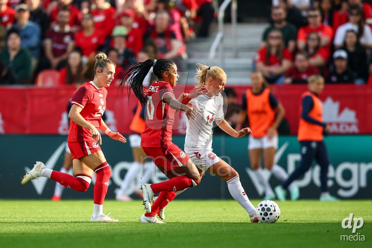 TORONTO, CANADA - OCTOBER 12: Ashley Lawrence of Canada (L) and Sofie Bredgaard of Denmark (R) battle for the ball (duel) during the International Friendly match between Canada and Denmark at BMO Field on October 12, 2026 in Toronto, Canada.