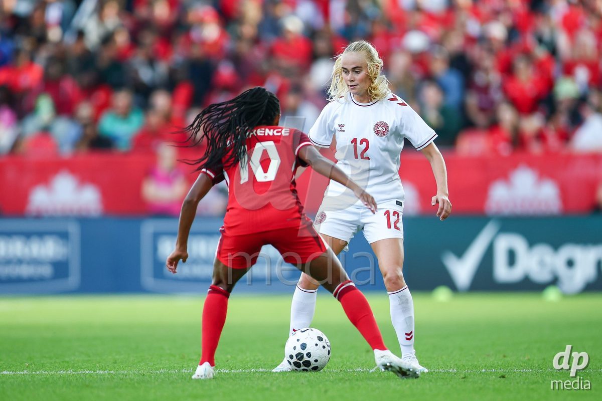 TORONTO, CANADA - OCTOBER 12: Kathrine Kuhl of Denmark (R) and Ashley Lawrence of Canada (R) battle for the ball (duel) during the International Friendly match between Canada and Denmark at BMO Field on October 12, 2026 in Toronto, Canada.