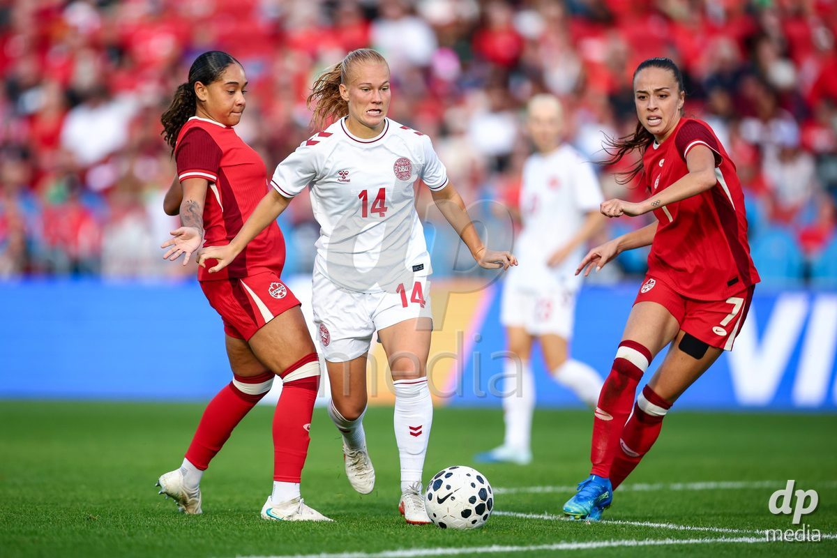 TORONTO, CANADA - OCTOBER 12: Olivia Smith of Canada (L) and Julia Grosso of Canada (R) battle against Sofie Bredgaard of Denmark (C) during the International Friendly match between Canada and Denmark at BMO Field on October 12, 2026 in Toronto, Canada.