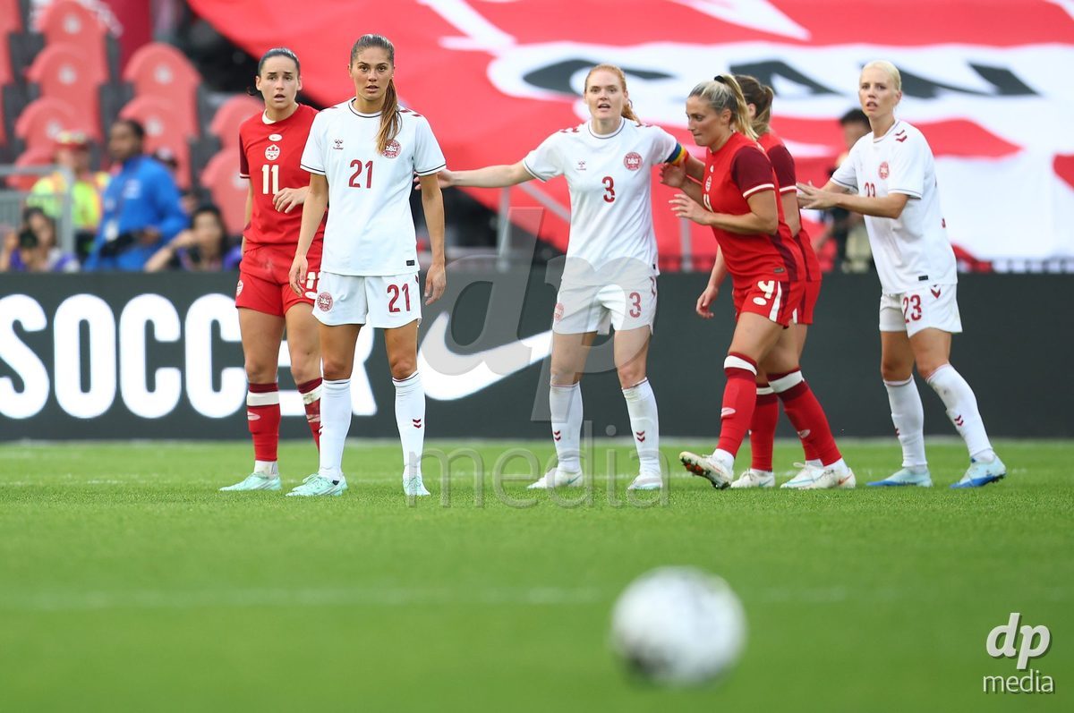 TORONTO, CANADA - OCTOBER 12: Mille Gejl, Stine Ballisager Pedersen and Sofie Svava of Denmark prepare for a free kick during the International Friendly match against Canada at BMO Field on October 12, 2026 in Toronto, Canada.