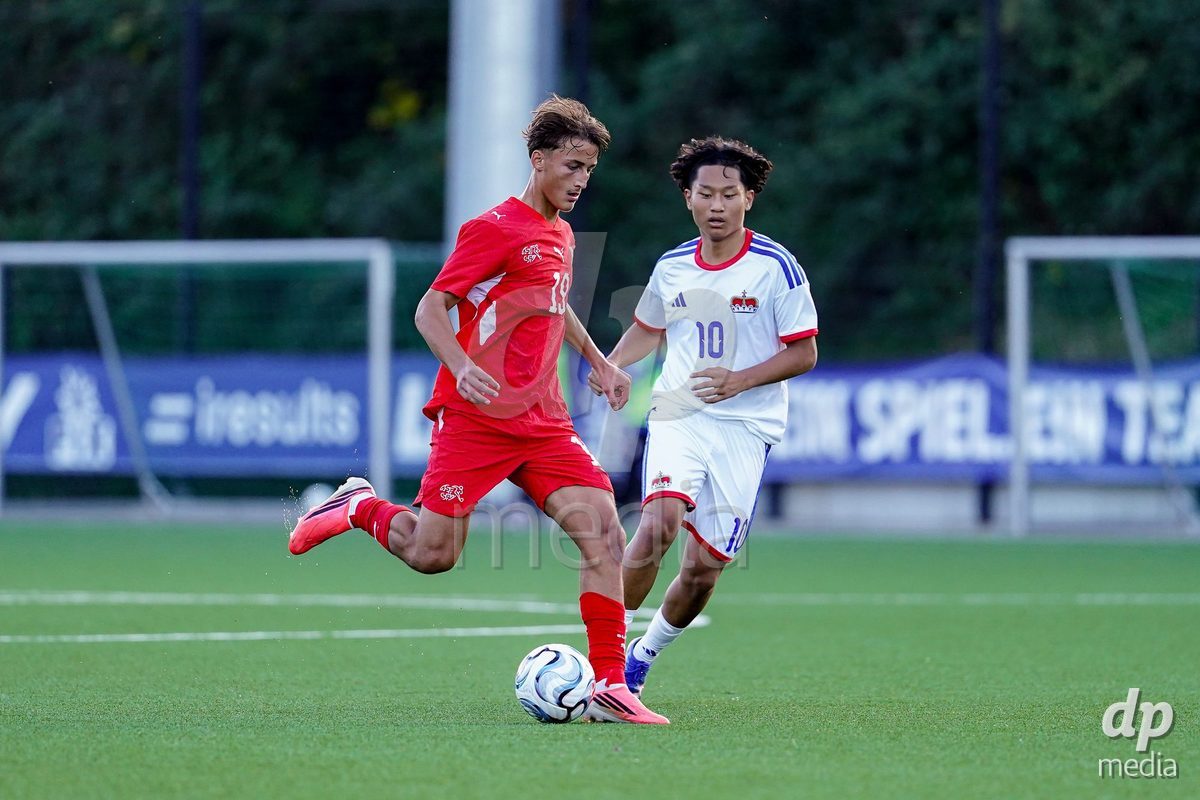 SCHAAN, LIECHTENSTEIN - OCTOBER 15: Eron Dreshaj of Switzerland and Tenzin Charaka of Liechtenstein battle for the ball during the UEFA European Under-17 Qualifier match between Switzerland and Liechtenstein at LFV Campus Rheinwiese on October 15, 2026 in Schaan, Liechtenstein.