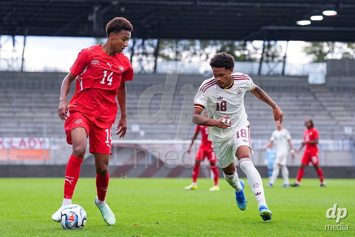 VADUZ, LIECHTENSTEIN - OCTOBER 18: Ryan Hare of Switzerland (L) and Darek Barriento of Spain (R) battle for the ball (duel) during the UEFA European Under-17 Qualifier match between Switzerland and Spain at Rheinpark Stadion on October 18, 2026 in Vaduz, Liechtenstein.