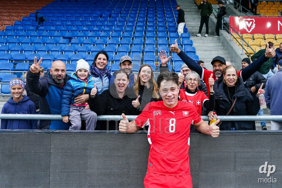 VADUZ, LIECHTENSTEIN - OCTOBER 18: Leandro Cottiati of Switzerland celebrates after the victory and poses for a photo with family and friends during the UEFA European Under-17 Qualifier match between Switzerland and Spain at Rheinpark Stadion on October 18, 2026 in Vaduz, Liechtenstein.