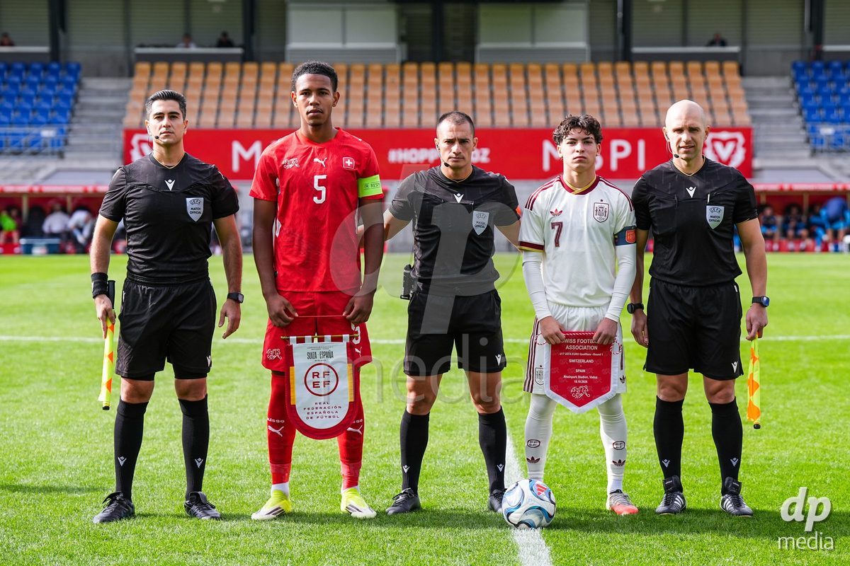 VADUZ, LIECHTENSTEIN - OCTOBER 18: Matchofficials (referees) and captains Noah Kakor of Switzerland and Joaquin Sanchez of Spain pose for a photo prior to the UEFA European Under-17 Qualifier match between Switzerland and Spain at Rheinpark Stadion on October 18, 2026 in Vaduz, Liechtenstein.