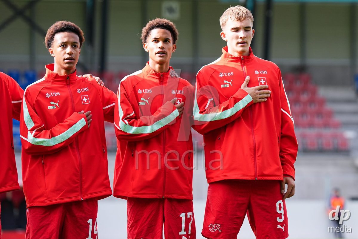VADUZ, LIECHTENSTEIN - OCTOBER 18: Ryan Hare, Kyle Kurt and Niko Cavka of Switzerland during the national anthem prior to the UEFA European Under-17 Qualifier match between Switzerland and Spain at Rheinpark Stadion on October 18, 2026 in Vaduz, Liechtenstein.