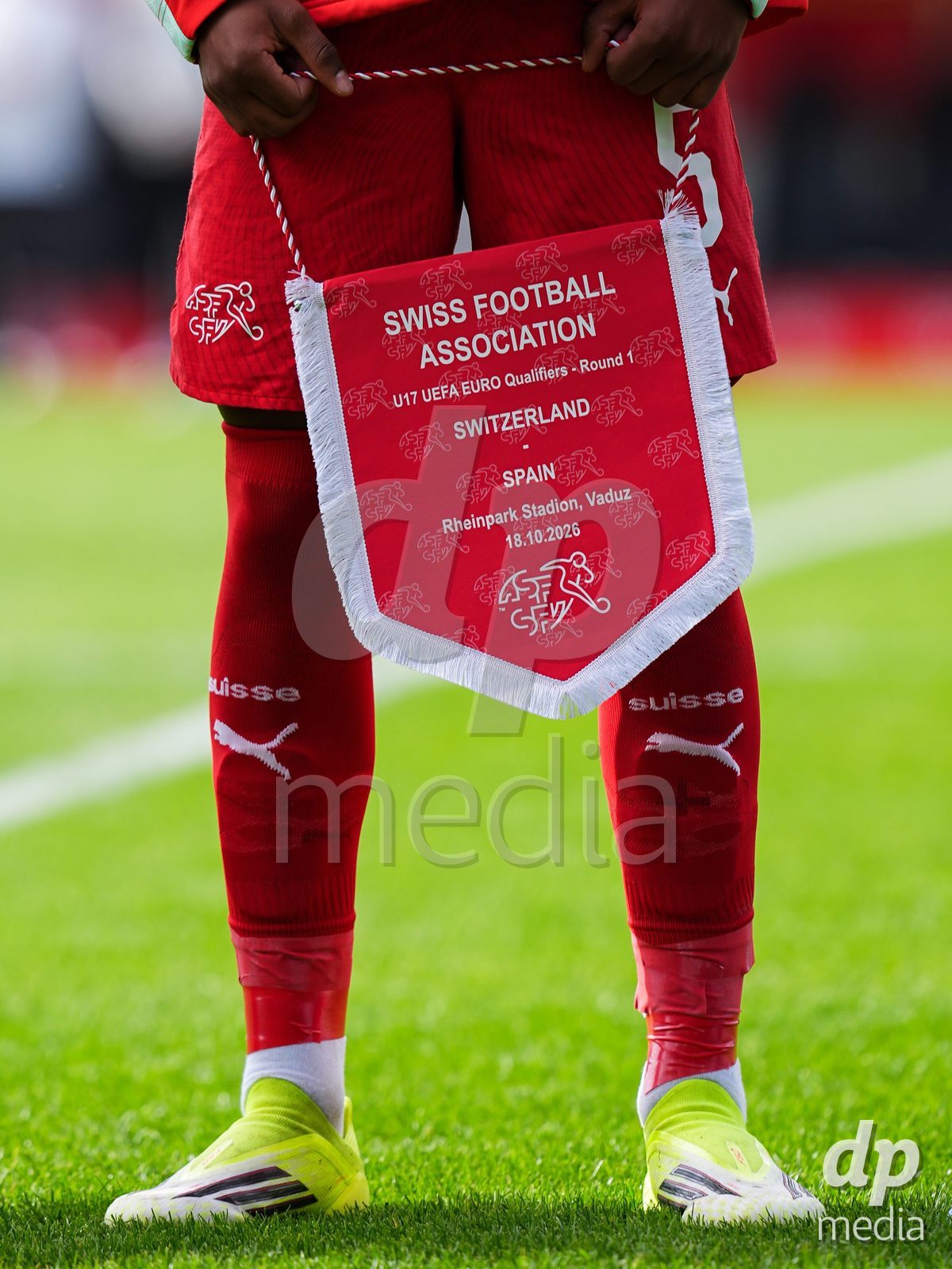 VADUZ, LIECHTENSTEIN - OCTOBER 18: Pennant of Switzeralnd hold by Noah Kakor of Switzerland during the UEFA European Under-17 Qualifier match between Switzerland and Spain at Rheinpark Stadion on October 18, 2026 in Vaduz, Liechtenstein.