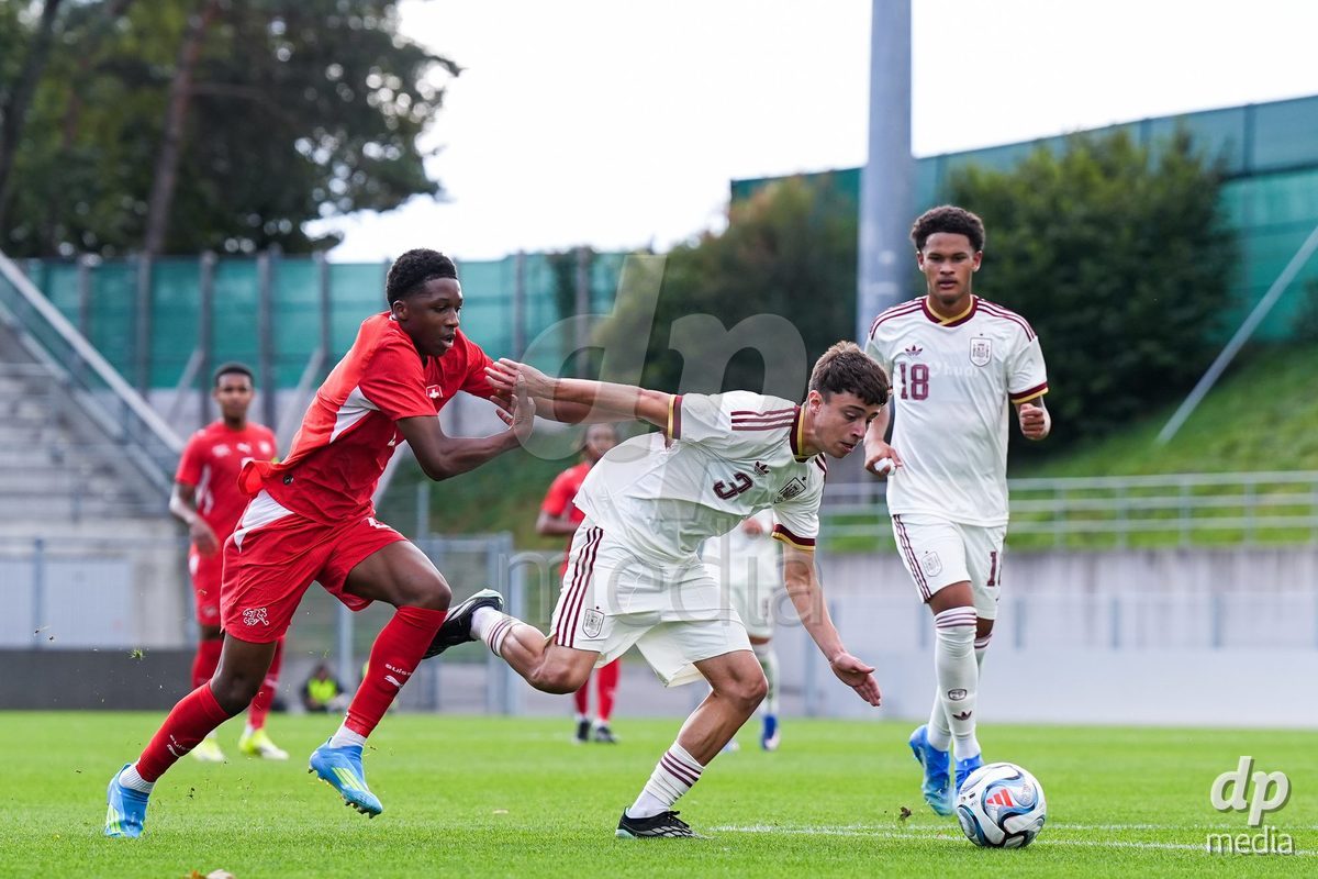 VADUZ, LIECHTENSTEIN - OCTOBER 18: Darren Okoh of Switzerland (L) and Marc Santos of Spain (R) battle for the ball (duel) during the UEFA European Under-17 Qualifier match between Switzerland and Spain at Rheinpark Stadion on October 18, 2026 in Vaduz, Liechtenstein.