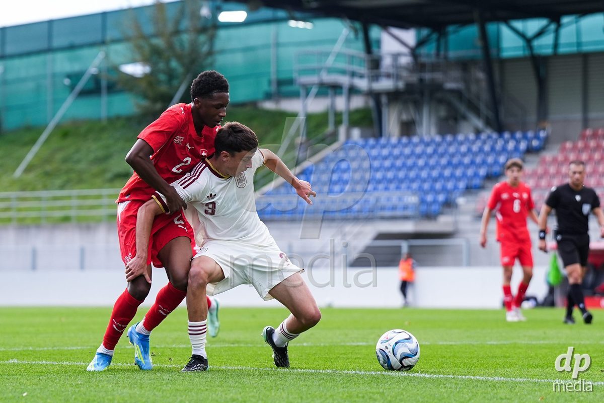 VADUZ, LIECHTENSTEIN - OCTOBER 18: Darren Okoh of Switzerland (L) and Marc Santos of Spain (R) battle for the ball (duel) during the UEFA European Under-17 Qualifier match between Switzerland and Spain at Rheinpark Stadion on October 18, 2026 in Vaduz, Liechtenstein.