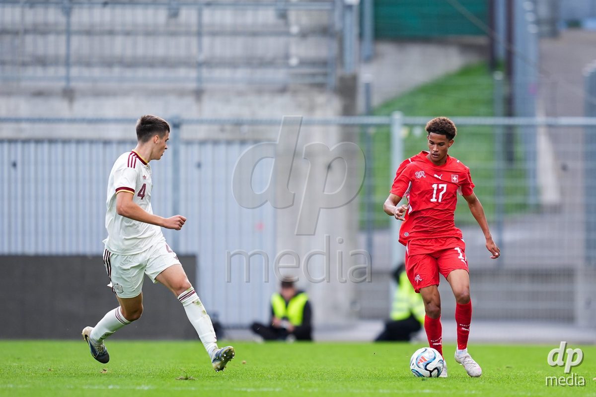 VADUZ, LIECHTENSTEIN - OCTOBER 18: Kyle Kurt of Switzerland (R) controls the ball during the UEFA European Under-17 Qualifier match between Switzerland and Spain at Rheinpark Stadion on October 18, 2026 in Vaduz, Liechtenstein.