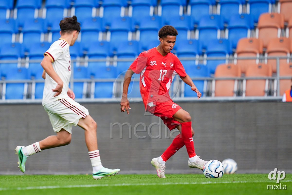 VADUZ, LIECHTENSTEIN - OCTOBER 18: Kyle Kurt of Switzerland (R) controls the ball during the UEFA European Under-17 Qualifier match between Switzerland and Spain at Rheinpark Stadion on October 18, 2026 in Vaduz, Liechtenstein.