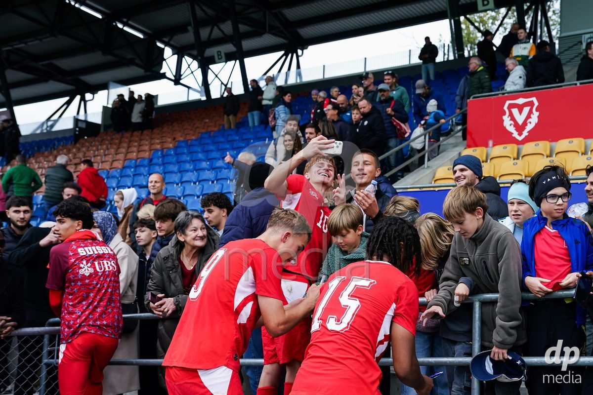 VADUZ, LIECHTENSTEIN - OCTOBER 18: Niko Cavka of Switzerland and Leon White of Switzerland with fans during the UEFA European Under-17 Qualifier match between Switzerland and Spain at Rheinpark Stadion on October 18, 2026 in Vaduz, Liechtenstein.