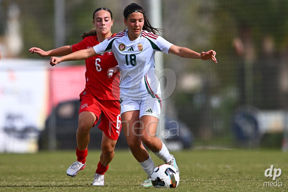 OLIVA NOVA, SPAIN - OCTOBER 24: Virag Sipos-Kiss of Hungary competes for the ball with Amelie Zorgiebel of Switzerland during the International Women's Friendly match between Switzerland U17 and Hungary U17 at Oliva Nova Sports Center on October 24, 2026 in Oliva Nova, Spain.