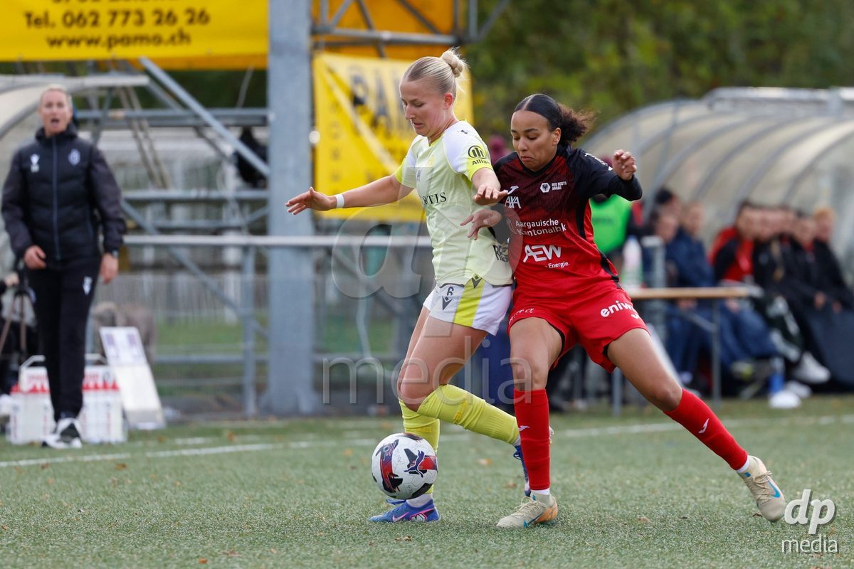 AARAU, SWITZERLAND - OCTOBER 24: Fabia Reinschmidt of FC Basel 1893 (L) and Joy Steck of FC Aarau Frauen (R) fighting for the ball during the AXA Women's Cup match between FC Aarau Frauen and FC Basel 1893 at Sportanlage Schachen on October 24, 2026 in Aarau, Switzerland.